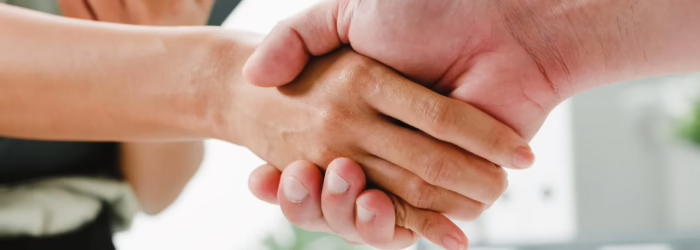 Multiracial group young creative people smart casual wear discussing business shaking hands together